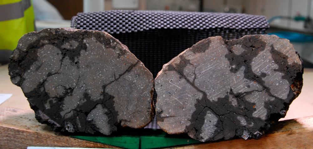 Basalt sample with 3mm plagioclase feldspar phenocrysts and altered olivine crystals.